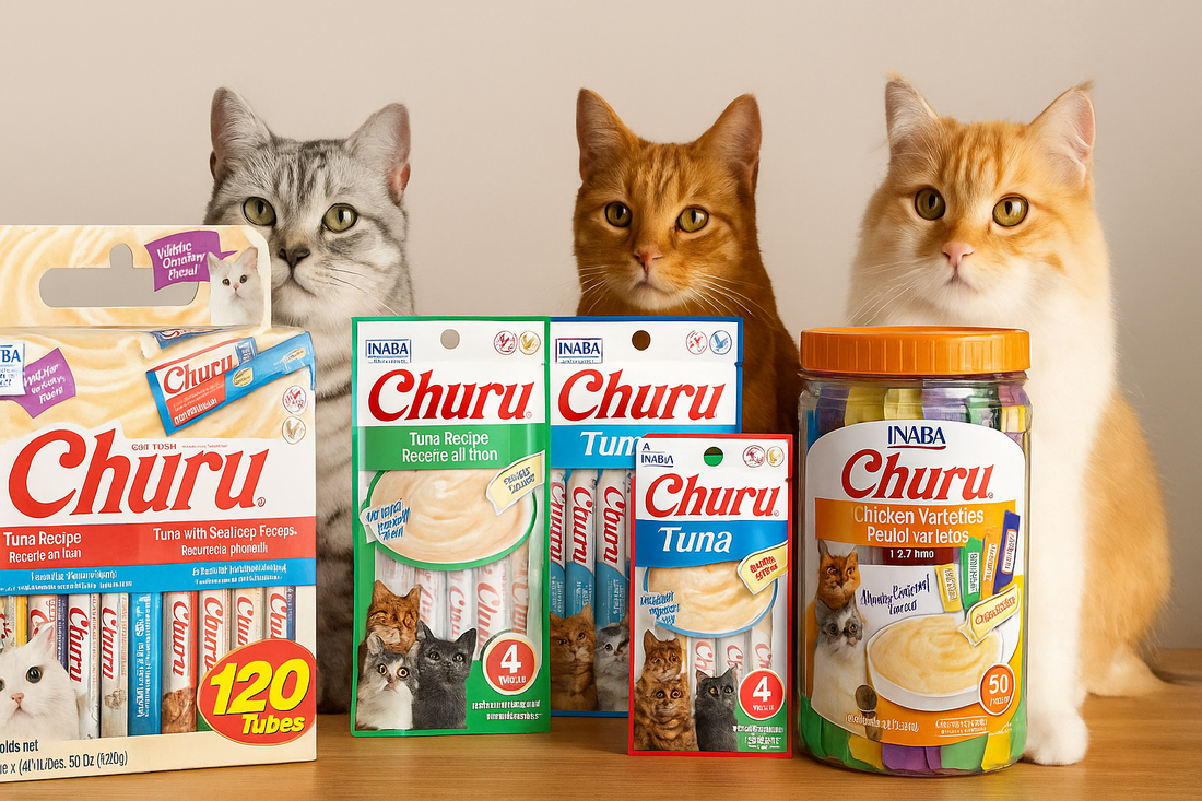 A group of four cats—tabby, orange, cream, and grey—sit behind neatly arranged Churu cat treats in boxes, pouches, and a jar on a wooden table, with soft indoor lighting.
